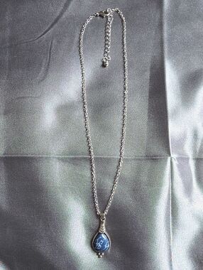 Bohemian-style teardrop pendant necklace features a blue Stone Silvertone
